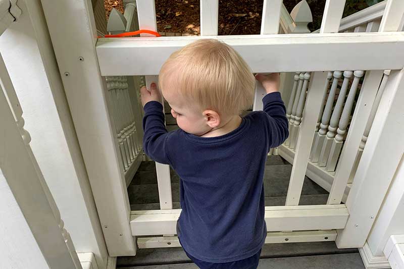 child with baby gate